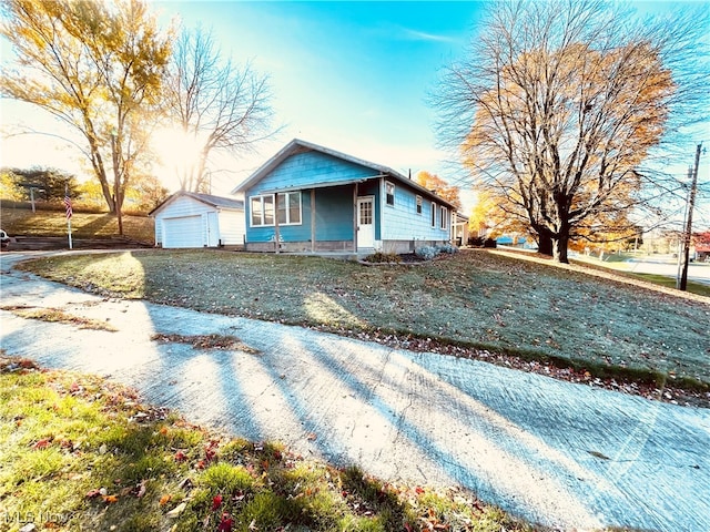 bungalow-style house featuring an outbuilding and a garage