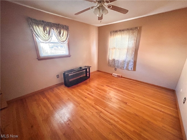 spare room with ceiling fan and wood-type flooring