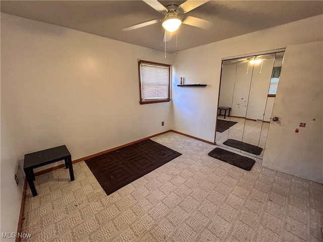 interior space featuring light colored carpet and ceiling fan