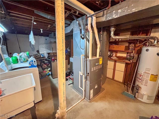 basement featuring gas water heater, sink, washer / clothes dryer, and heating unit