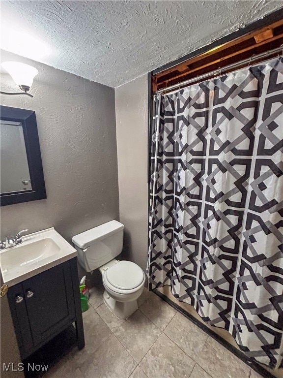 bathroom with tile patterned floors, vanity, and toilet