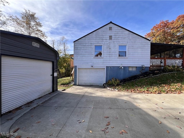 view of property exterior featuring a carport and a garage