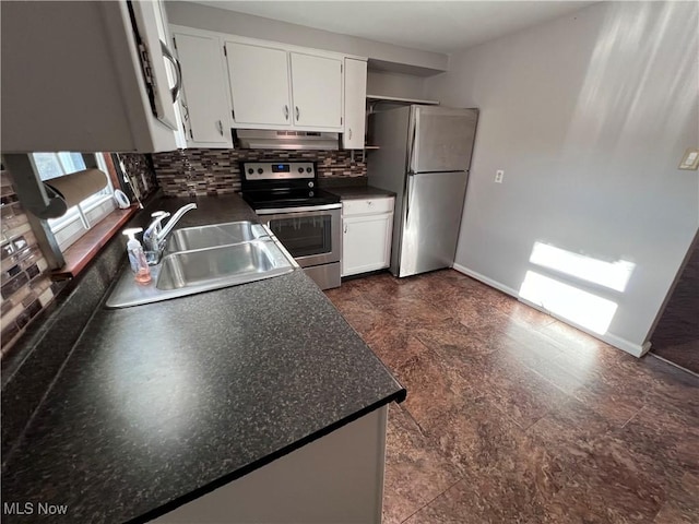 kitchen with tasteful backsplash, sink, white cabinets, and stainless steel appliances