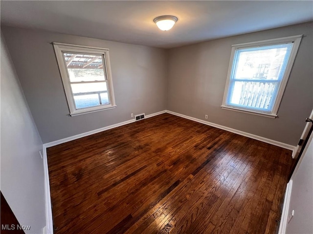 unfurnished room featuring dark hardwood / wood-style floors