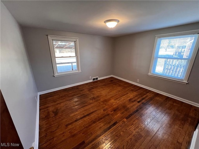 empty room featuring dark wood-type flooring