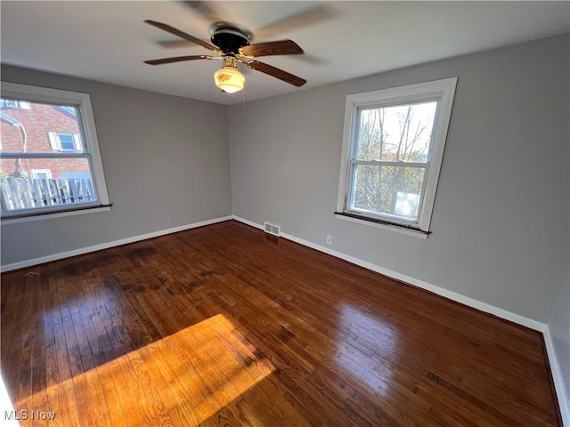 empty room featuring hardwood / wood-style floors and ceiling fan