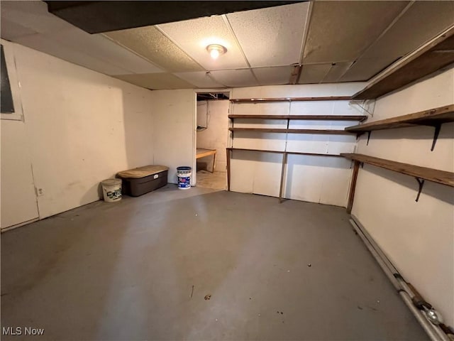 basement featuring a paneled ceiling