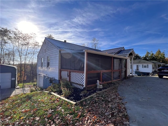 view of property exterior with a sunroom