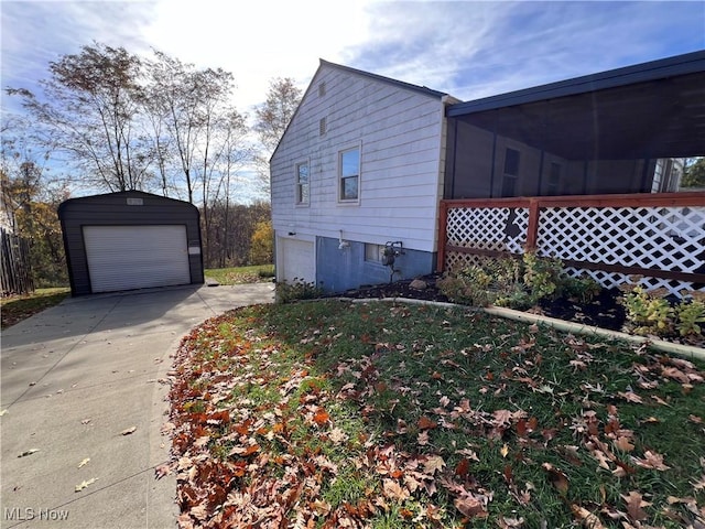 view of side of home featuring a sunroom and a garage