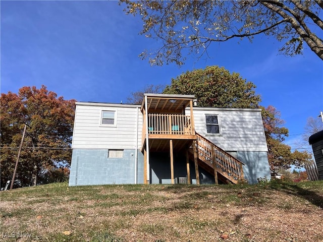 back of house with a deck