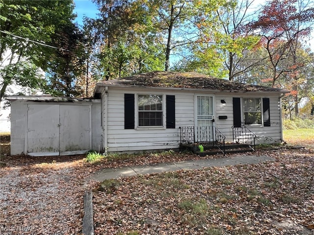 view of front of house with a storage unit