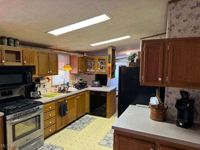 kitchen with black appliances and a textured ceiling