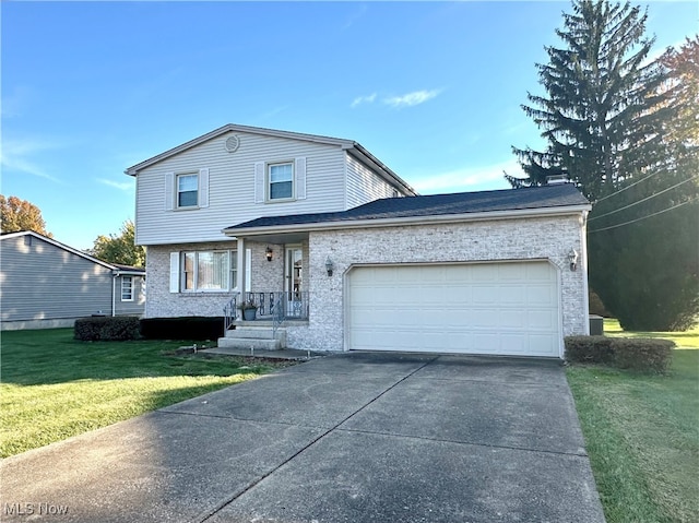 view of front of house with a garage and a front lawn