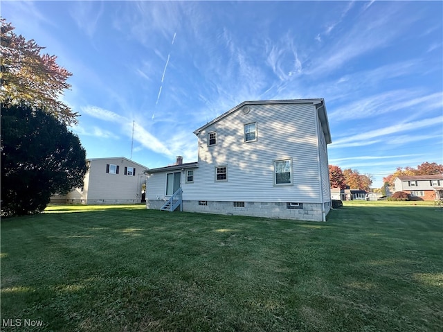 view of home's exterior with a lawn