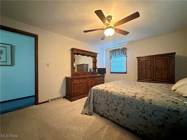 bedroom with light colored carpet and ceiling fan