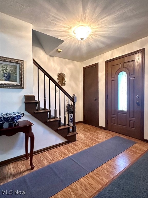 entryway with hardwood / wood-style floors