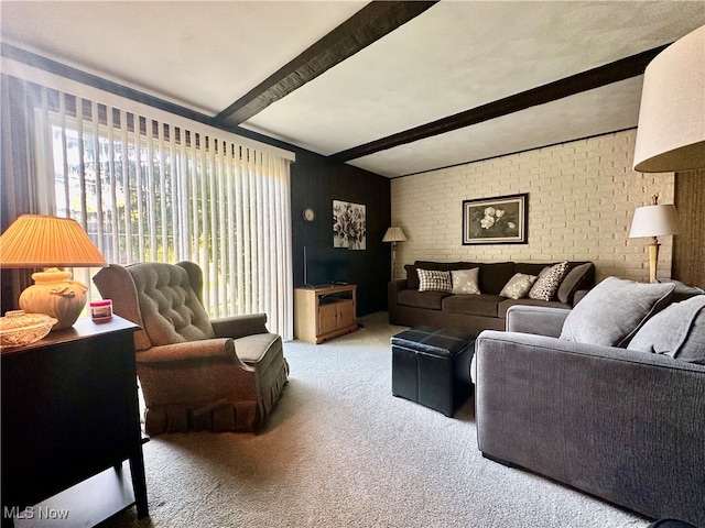 living room featuring brick wall, beamed ceiling, and light colored carpet