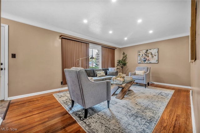 living room featuring crown molding and hardwood / wood-style floors