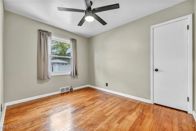 empty room featuring light hardwood / wood-style flooring and ceiling fan