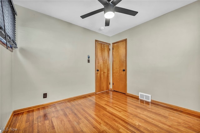 empty room with light hardwood / wood-style floors and ceiling fan