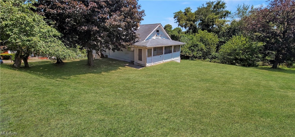 view of yard featuring a sunroom