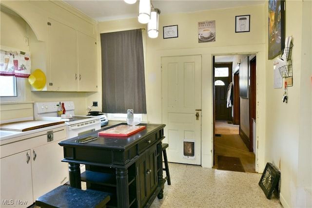 kitchen with white cabinets, white electric range, and decorative light fixtures