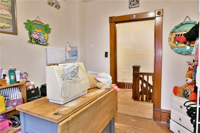 home office with light hardwood / wood-style flooring