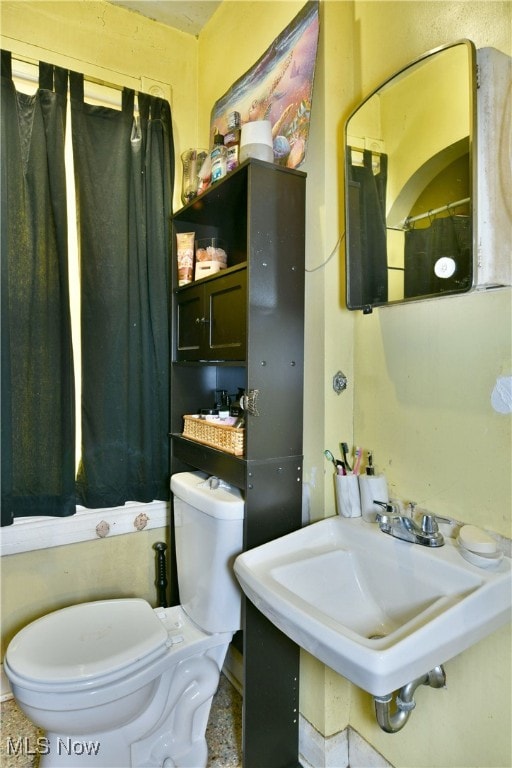 bathroom featuring sink and toilet