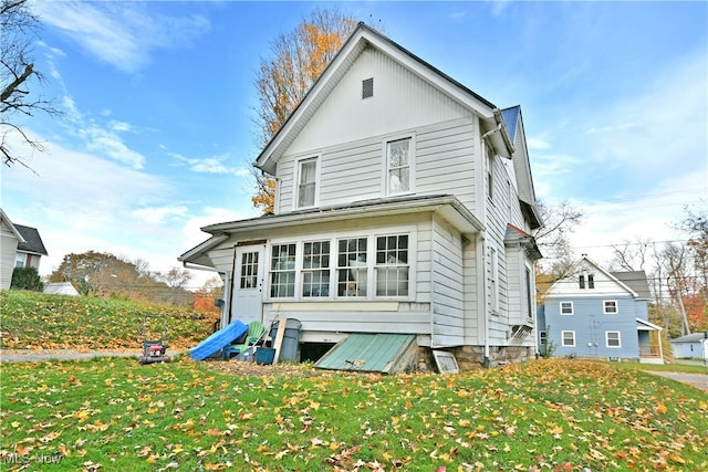 rear view of property featuring a yard