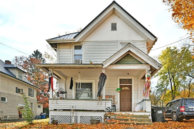 view of front of house with cooling unit and a porch