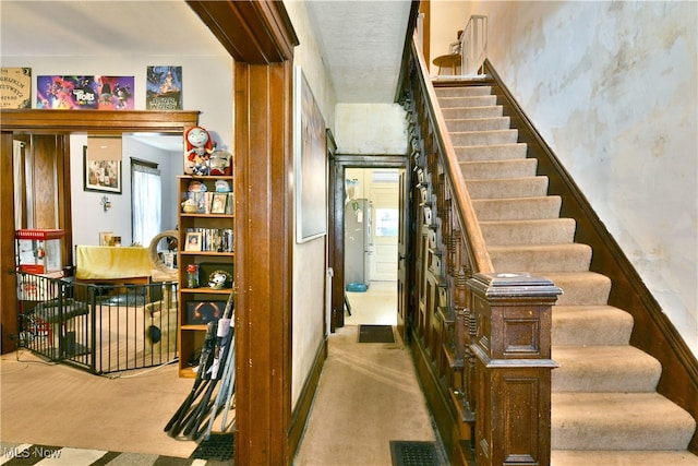 stairway with a healthy amount of sunlight and carpet