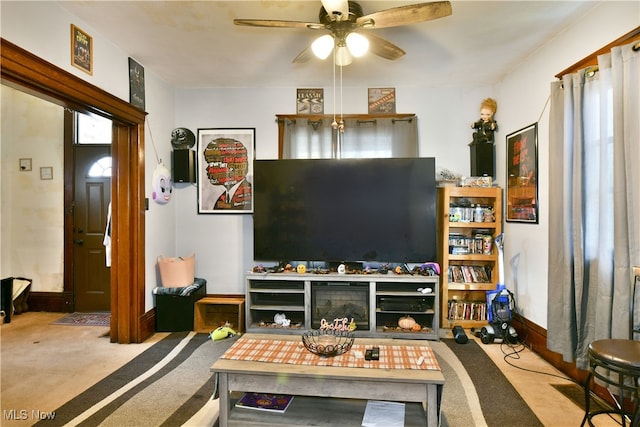 carpeted living room with ceiling fan