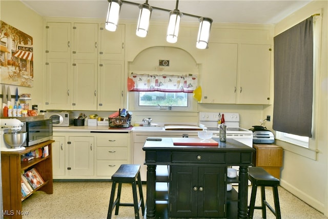 kitchen featuring white cabinets, white electric range oven, sink, and pendant lighting