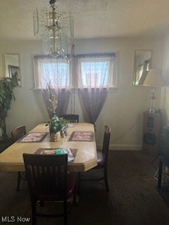 dining space with an inviting chandelier