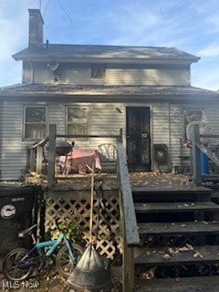 rear view of house with a wooden deck