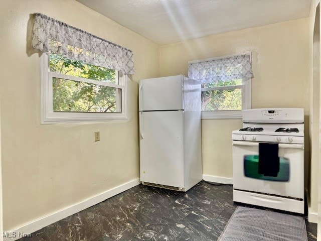 kitchen featuring white appliances and plenty of natural light