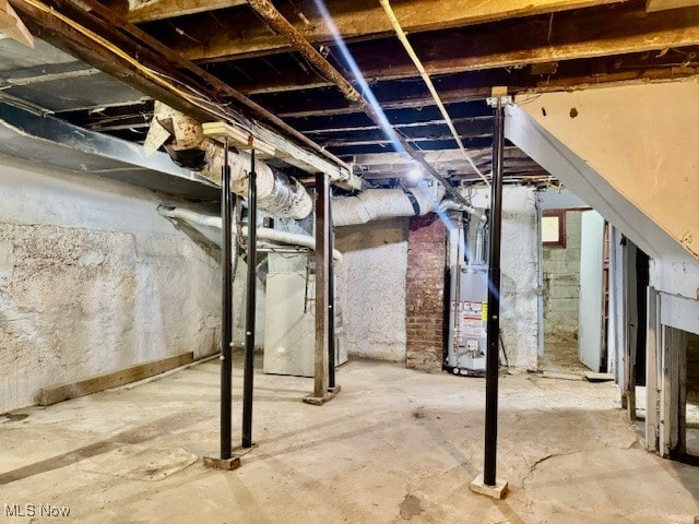 basement with gas water heater and heating unit