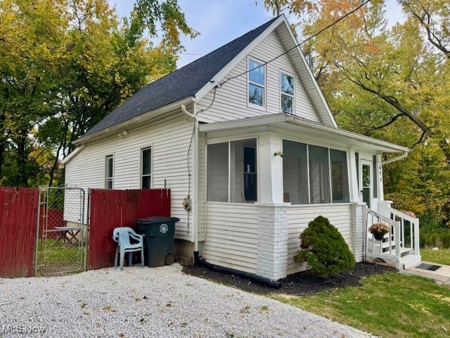 view of side of property featuring a sunroom