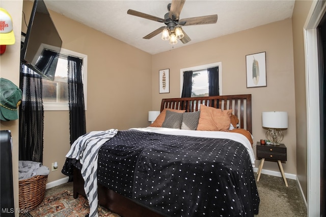 bedroom featuring multiple windows, carpet floors, and ceiling fan