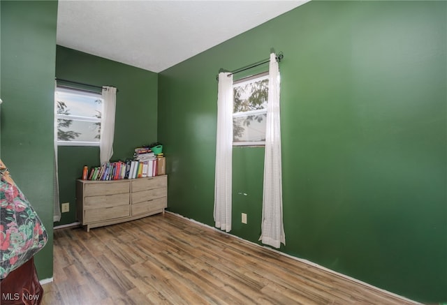 bedroom with hardwood / wood-style flooring