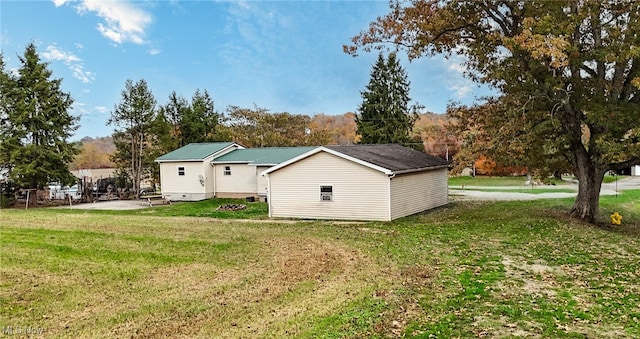 view of side of home with a yard