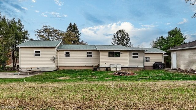 back of property with a patio and a lawn