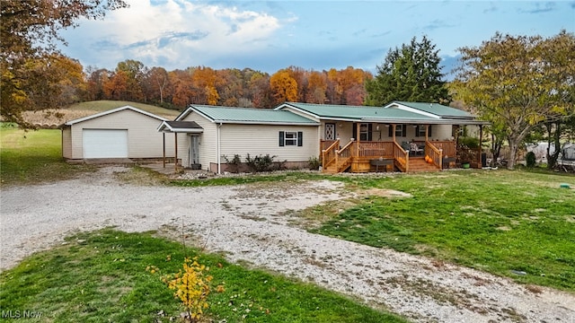 view of front of home featuring an outbuilding, a front lawn, and a garage