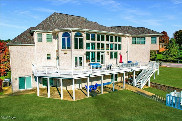 rear view of property featuring cooling unit, a yard, and a deck