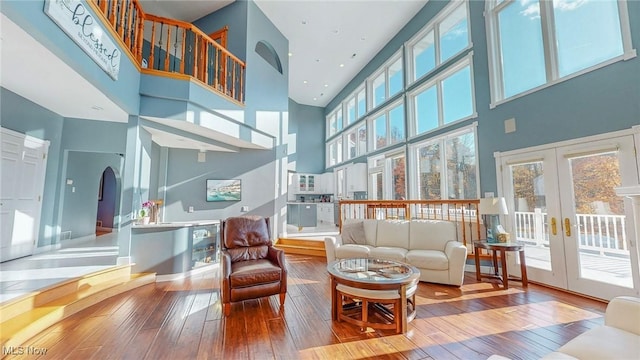 282 Orlando Mnr, Wintersville, OH 43953 - living room featuring a towering ceiling, wood-type flooring, plenty of natural light, and french doors