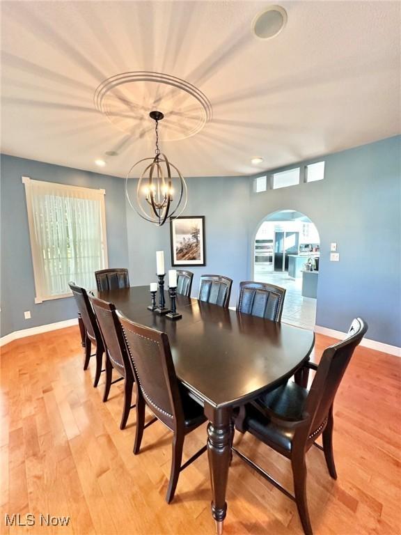 282 Orlando Mnr, Wintersville, OH 43953 - dining space with arched walkways, light wood-type flooring, a chandelier, baseboards, and recessed lighting
