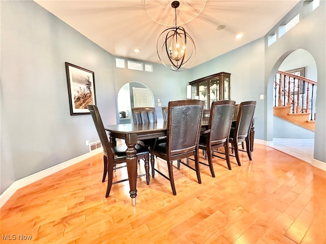 dining space featuring light hardwood / wood-style floors and a chandelier