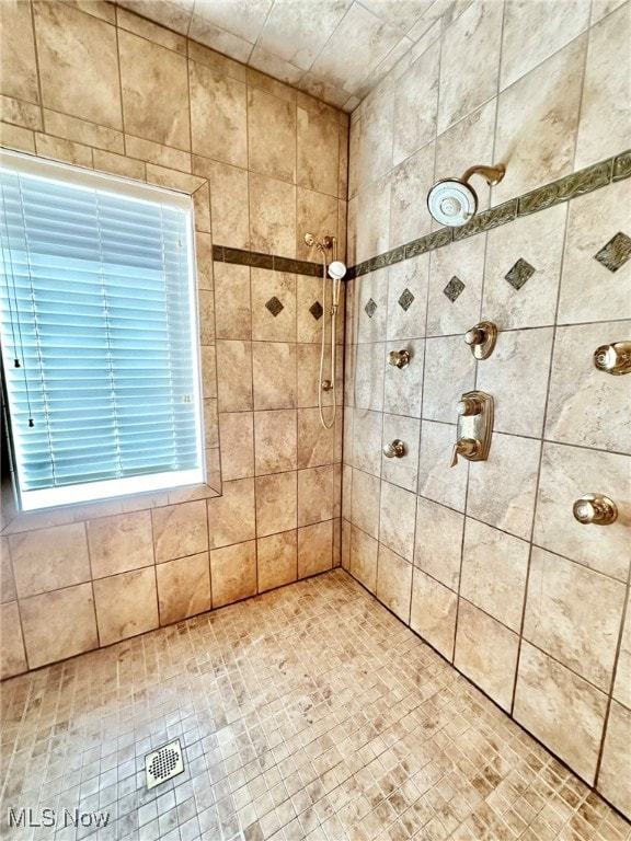 bathroom with a tile shower