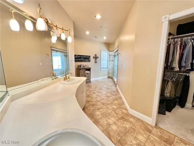 bathroom with vanity and a shower with door