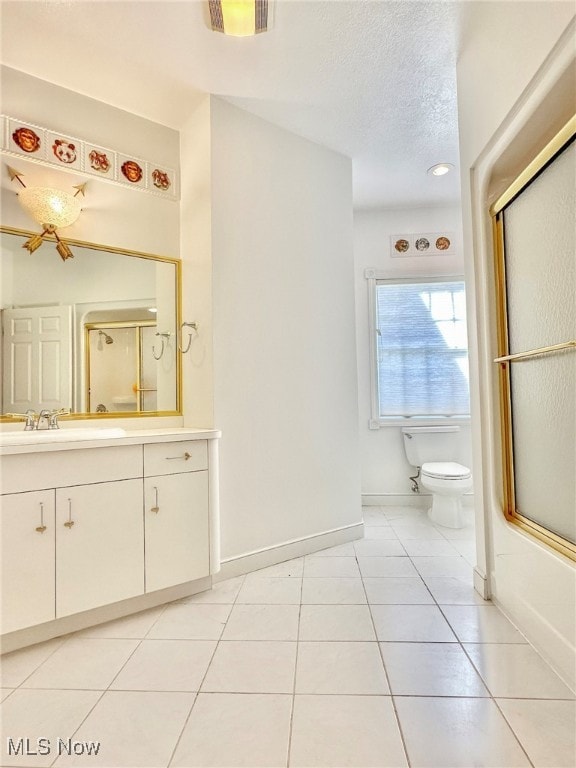 full bathroom with vanity, toilet, tile patterned flooring, and bath / shower combo with glass door